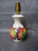 A MOORCROFT LEAF AND BERRY PATTERN TABLE LAMP, impressed marks and remnants of original sticker,