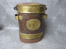 A LATE VICTORIAN BRASS AND STEEL MILK CHURN, of oval form, with hinged lid and swing handle, brass