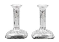 An Edwardian pair of silver weighted candlesticks by Mark Ellis & Co.