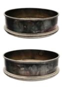 A pair of modern silver wine coasters.