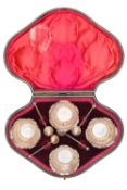 A Victorian silver set of four salts and spoons within original fitted case by Hilliard & Thomason.