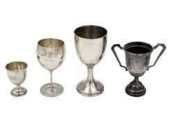 A group of four silver pedestal cups.