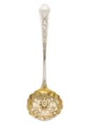 A George III silver sifting spoon.