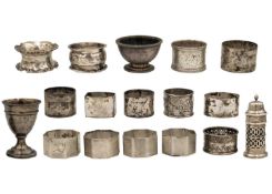 A quantity of silver napkin rings, two salts and an egg cup.