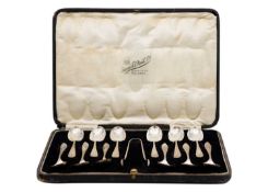A George V silver cased set of twelve teaspoons and sugar tongs by Cooper Brothers & Sons Ltd.