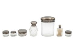 A collection of six silver lidded cut glass dressing table jars.
