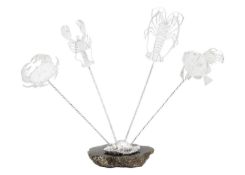 A .999 fine silver set of four 'Fish' olive picks on a labradorite shell base by James Suddaby.