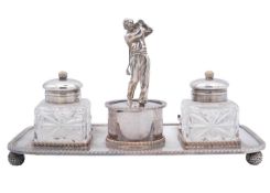 An silver plate on copper novelty golfing ink stand.