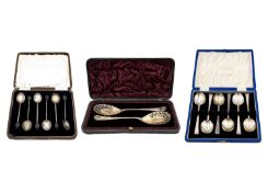 A selection of three silver cased spoon sets.