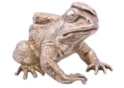 A modern heavy silver model of a frog.