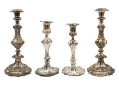 Two pairs of silver plated Rococo style candlesticks.