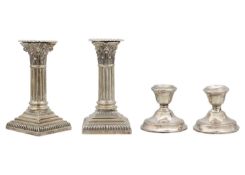 A Victorian silver pair of squat Corinthian column candlesticks by Hawksworth, Eyre & Co Ltd.