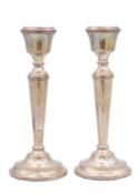A pair of silver candlesticks by A T Cannon Ltd.