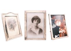 Three silver mounted photograph frames.