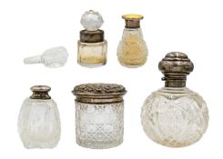 A selection of five silver-mounted cut glass dressing table bottles.