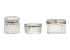 A 19th-century Russian silver pill box, a silver-lidded glass jar, and one other with plated lid.