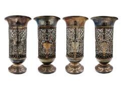 An Edwardian silver suite of four pierced pedestal vases by James Dixon & Sons.