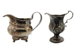 A George IV silver milk jug and a Georgian silver cream jug.