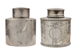 Two small silver tea caddies and covers.