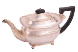 A mid-20th century silver teapot of boat form with gadrooned bands, the hinged domed cover with ebon