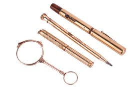 A pair of gold-mounted lorgnettes and a collection of pens; the Edwardian lorgnettes of fold-out for
