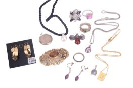 A group of silver and costume jewellery. The group consists of two brooches, four rings, a pair of h