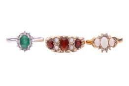 Three rings; including a 9ct yellow gold garnet and opal half-hoop ring with scrolling detail, hallm