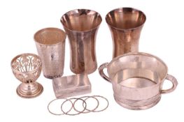 A white metal two-handled bowl stamped Sterling, a pair of white metal beakers, a white metal emboss
