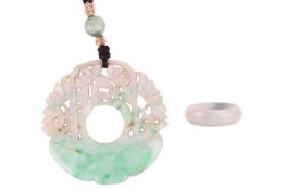 A jadeite hololith ring and a carved jadeite plaque; the hololith ring is carved from greyish jadeit