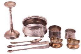 A collection of silver, consisting of four napkin rings, a sugar bowl, a candle stick, a pair of sug