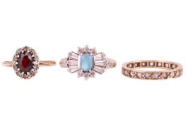Three rings comprising a 9ct gold garnet and paste cluster ring, size O, a blue topaz and paste clus