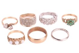 A collection of seven rings, comprising a diamond set lattice design half hoop ring marked '375', ri