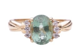 A Paraiba tourmaline and diamond set ring, featuring a central oval cut Paraiba tourmaline (Mozambiq