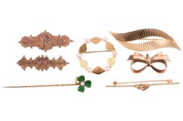 A small collection of jewellery including a seed pearl and enamel shamrock stick pin, in yellow meta