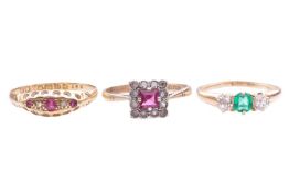 A collection of three gem set rings, the first features a central emerald flanked by two old cut dia