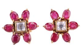 A pair of ruby and white sapphire cluster earrings; the central step cut sapphires in rub over mount