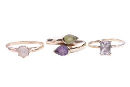 A gem-set crossover ring, the pear-shaped amethyst and peridot measuring approximately 6.5mm x 5mm e