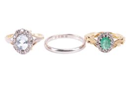 A collection of three rings, featuring two stone set cluster rings and a wedding band. The first 18c