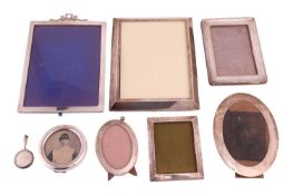 A collection of five silver photograph frames, the largest with ribbon bow crest, 22.5cm x 17.5cm, t