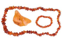 A group lot of amber, consisting of a beaded necklace, a beaded bracelet and a large piece of organi