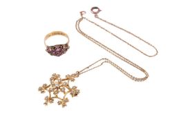 A split pearl floral pendant measuring 28 x 30mm, marked '9ct', with brooch pin fitting, with a chai