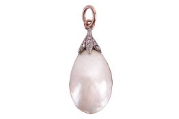 A mabe pearl and diamond pendant, featuring a drop shape mabe pearl to a diamond set mount, with a c