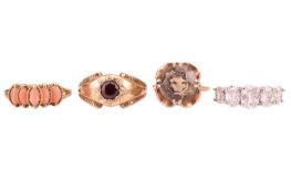 Four dress rings including a 9ct gold smoky quartz solitaire ring, size P; a 5-stone coral ring, the