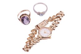 A collection of two rings and a lady's wristwatch; the Accurist wristwatch in yellow gold with hallm