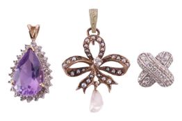 A collection of three pendants, featuring a pear-shaped amethyst set pendant in yellow metal stamped