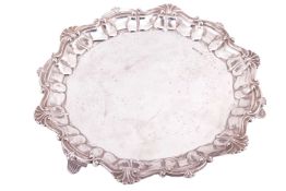 Lee & Wigfull (Henry Wigfull):- A silver salver with shell and scroll rim on three fluted splaye