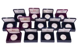 A collection of thirteen American one-ounce proof silver bullion coins, capsulated in individual cas