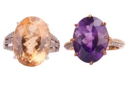 A citrine and diamond dress ring; the oval cut citrine with three-row diamond set shoulders in 9-car