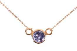 A solitaire tanzanite necklace, featuring a round light purple tanzanite, measuring approximately 6m