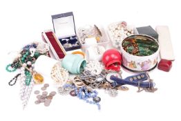A collection of costume jewellery, including bead necklaces, brooches, earrings, coins, imitation pe